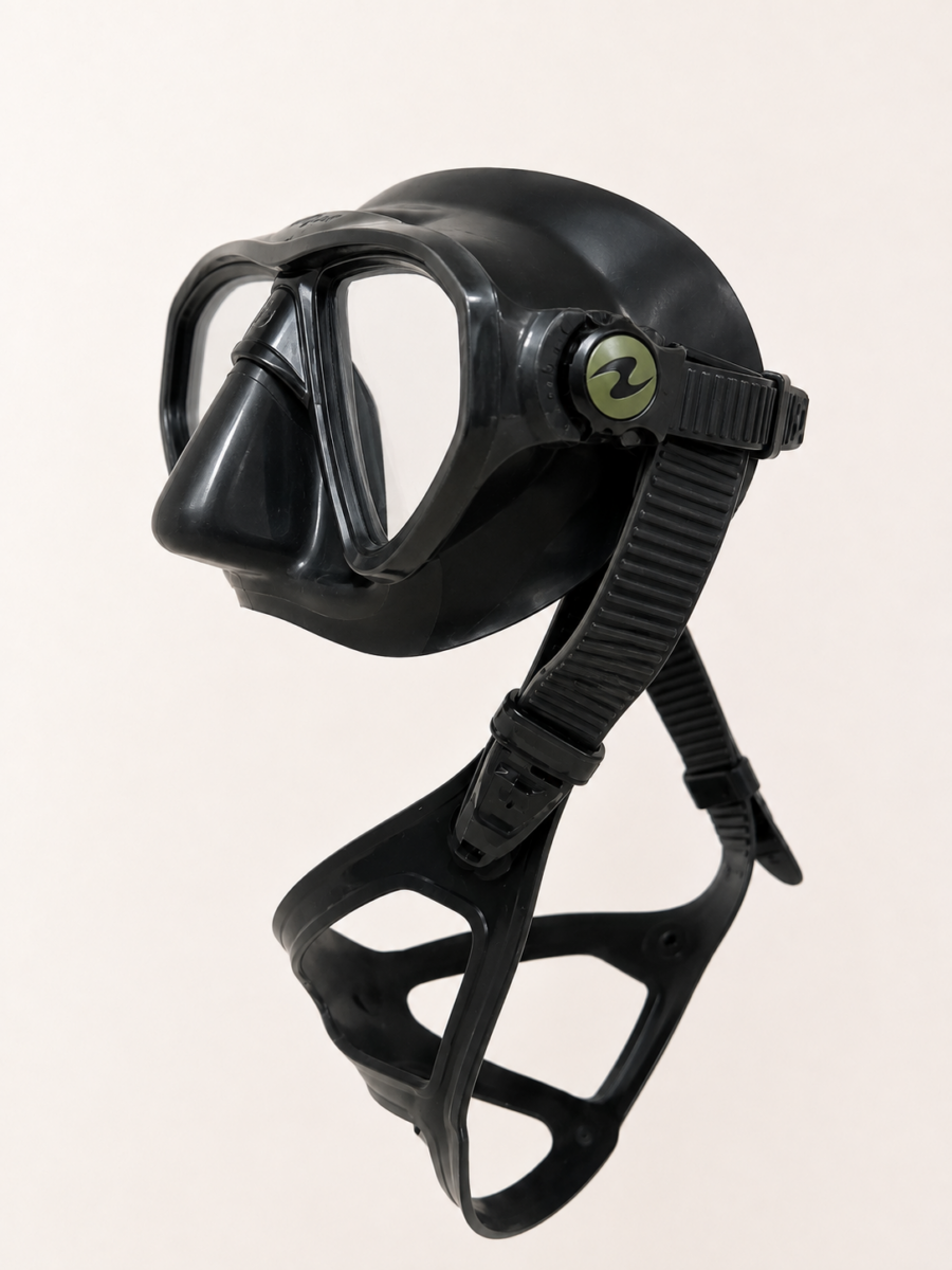 Side view of a scuba diving mask showing the adjustable strap and buckle mechanism